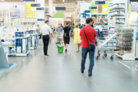 Blurred hardware store with building and finishing materials for home repair and improvement with customers.の写真素材