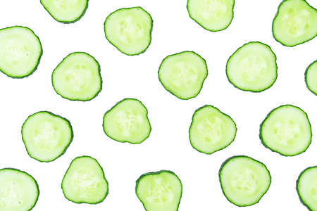 Sliced cucumber cross-sections isolated on white background. Abstract food pattern.の写真素材