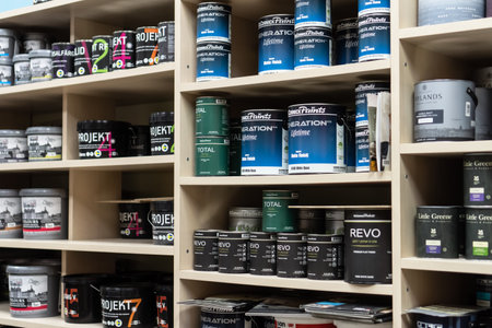 Russia, Moscow: June 28, 2021. Shelves with interior paints in cans in the shop.のeditorial素材