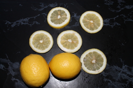 yellow lemons on the black marble backgroundの写真素材