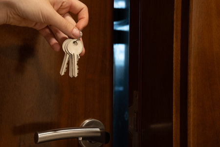 Two cute scarecrow dolls on orange background with flying bats. Fun, kid-friendly Halloween scene for banners and invitations.の写真素材