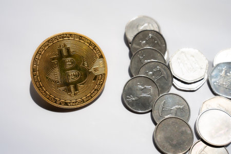 Golden Bitcoin cryptocurrency coin placed on top of mixed silver coins, symbolizing financial growth, trading, and crypto dominance.の写真素材