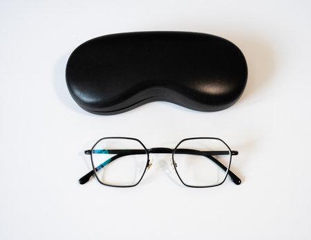 Glasses with black protective case on white background. Perfect for eye health, vision care, optometry, medical design and lifestyle concepts.の写真素材