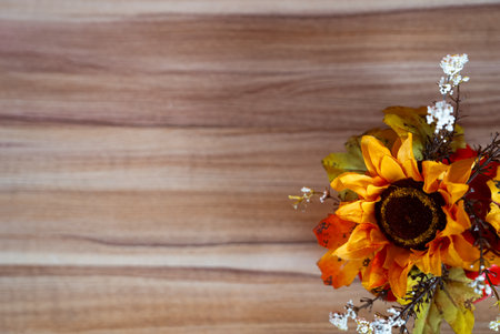 Bright autumn sunflower with seasonal decor on rustic wooden texture background. Perfect for fall holidays and Thanksgiving.の写真素材