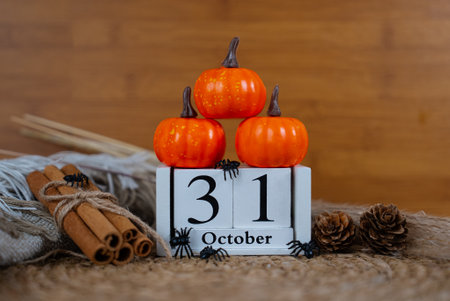 Minimal rustic composition with stacked pumpkins and October 31 calendar, perfect seasonal Halloween stock.の写真素材