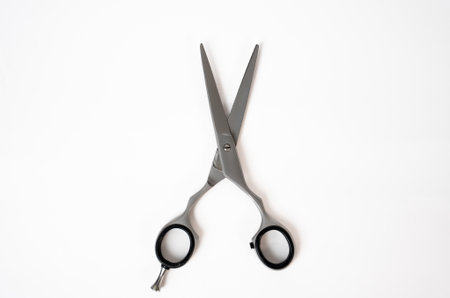 High-quality hairdressing scissors on minimal background. Suitable for salon, beauty, or barber tools themes.の写真素材