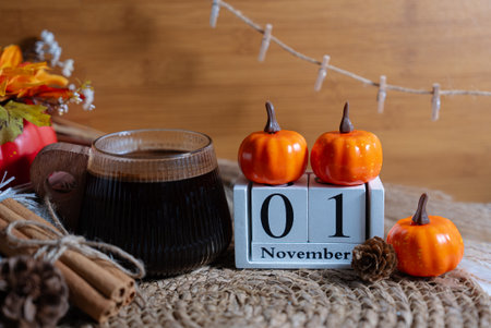 Autumn scene with pumpkins and rustic decor featuring November 1 wooden block calendar. Seasonal stock for fall and Halloween themes.の写真素材