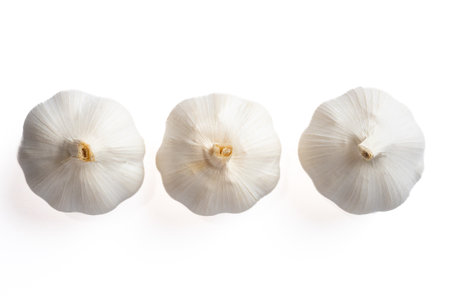 Fresh garlic heads arranged in a minimal composition. Ideal for healthy eating, organic food, and cooking themes.の写真素材