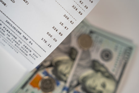 US dollar banknotes and printed receipt document, symbolizing payment, purchase, and money management.の写真素材