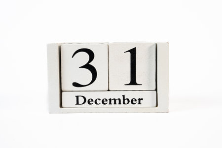Wooden block calendar showing December 31 on white background. Ideal for countdown, year-end, and...