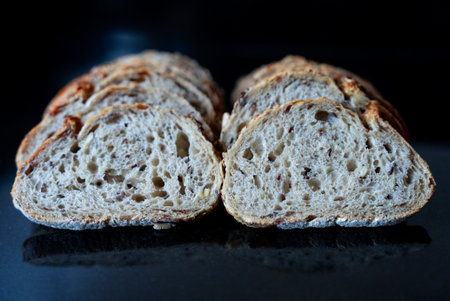Cross section of homemade bread loaf showing airy texture and crispy crust. Perfect for artisan food...
