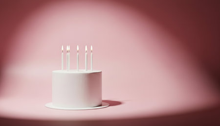 Minimal birthday cake with candles on soft pink background, studio-lit with empty right space for text. Perfect for invitations, ads, modern celebration visuals, and editorial content.の素材