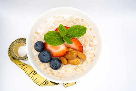 Healthy Oatmeal Breakfast Bowl with Fresh Berries, Almonds, and Mint. High quality photoの写真素材