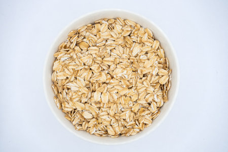 Simple bowl of oatmeal on white background, perfect for healthy eating concepts