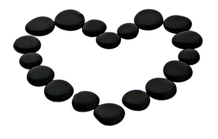 heart with a black stones on the white background の写真素材