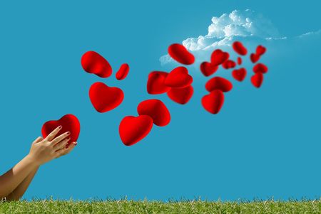 Heart fly into the sky from the handsの写真素材
