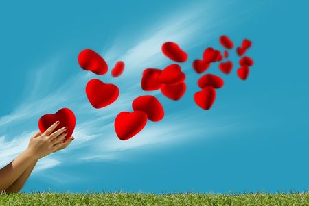 Heart fly into the sky from the handsの写真素材