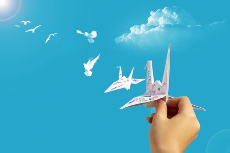 hand launch into the sky paper pigeonの写真素材