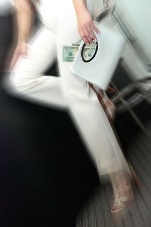 woman sitting on a chair at the bar with the moneyの写真素材