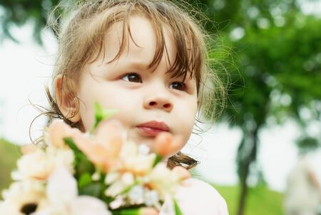 little girl in a park with flowersの写真素材