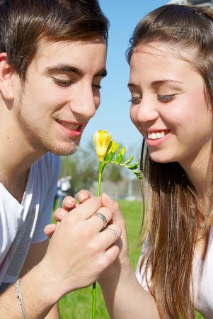 couple in love with a flower outdoors in the park の写真素材