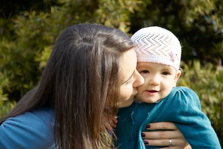 happy mother playing in park with daughter