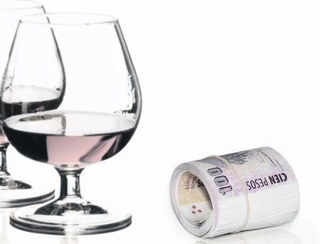 Roll of money and glasses isolated on white backgroundの写真素材