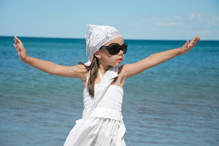 little girl in sunglasses on the beachの写真素材