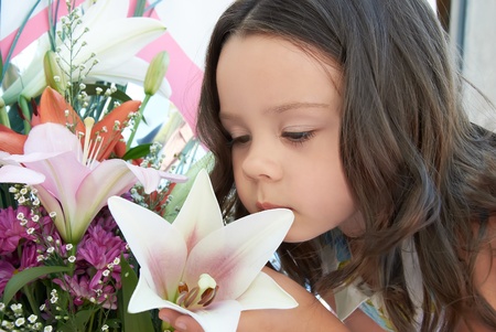 cute little girl with flowers, a gift for mothers day or valentineの写真素材