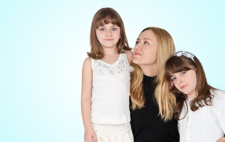 Happy family, loving mother hugging her kidsの写真素材