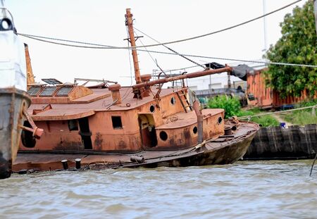 An old rusty ship on dry landの写真素材