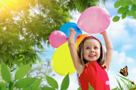 beautiful little girl playing with balloonsの写真素材
