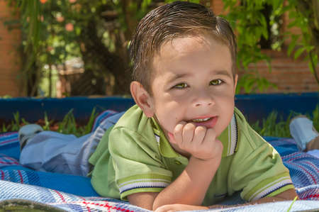 Portrait of happy cute child in the grassの写真素材