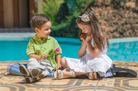 The little boy gives to the girl a flower  の写真素材
