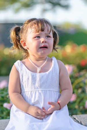 Little crying girl in parkの写真素材