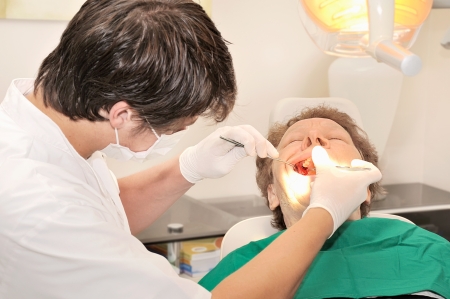 Image dentist treating the patientの写真素材
