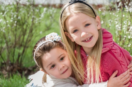 two beautiful little girls in parkの写真素材