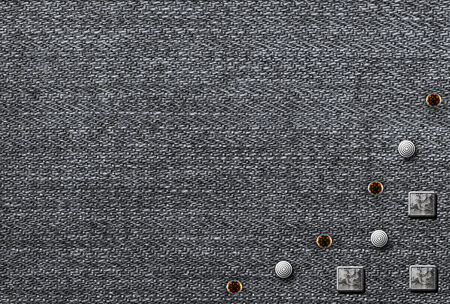 Metal rivets on the denim backgroundの写真素材