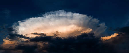 Dramatic sky before thunderstorm, big cumulus nimbus in the sunset