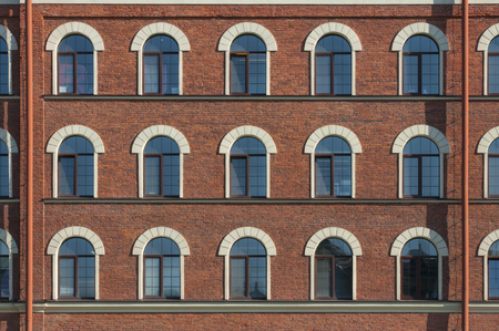 Many equal windows of the factory in Saint Petersburg city in Russiaの写真素材
