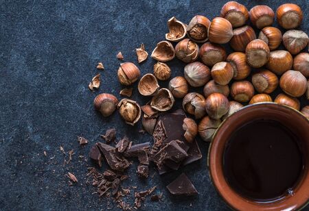 well nut chocolate and tea on a dark table . Top view.の写真素材