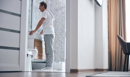 Handsome man staring at himself in the mirrorの写真素材