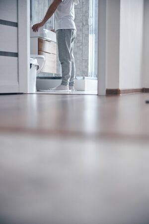 Male in socks standing on the bath matの写真素材