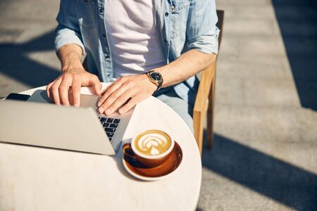 Focused photo on male hands that typing messageの写真素材