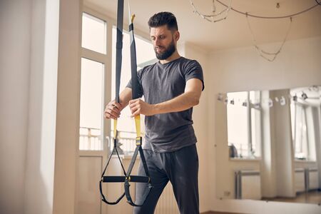 Concentrated man preparing for the strength workoutの写真素材