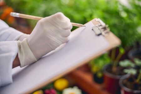 Biologist holding a clipboard in her handsの写真素材