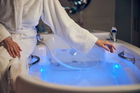 Caucasian female preparing for a hydrotherapy procedureの写真素材