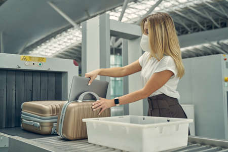 Attentive young female person taking her laptopの写真素材