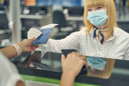 Close up of young woman taking her passportの写真素材