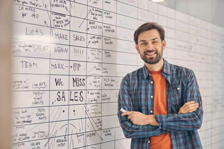 Handsome young man standing in modern office